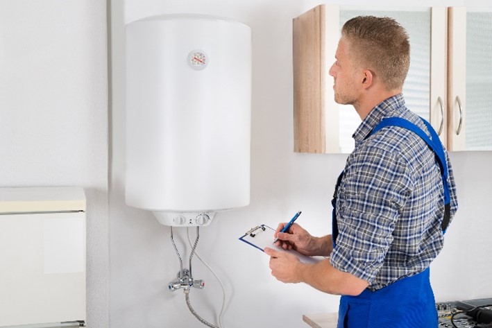 Technician providing maintenance to a water heater in the home of a Chicagoland resident.