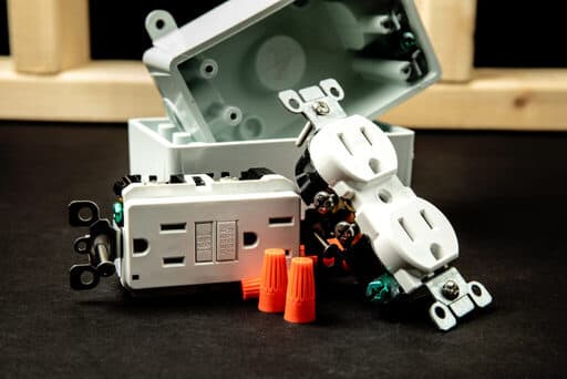 Outlet parts sitting on black background.