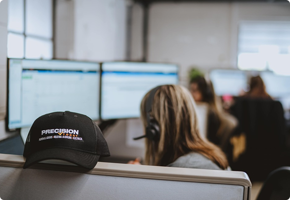 Precision Today sales team members working at computer workstations in the call center