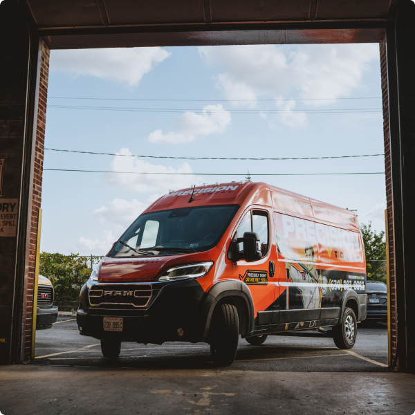 Precision Today service van parked in an open garage bay